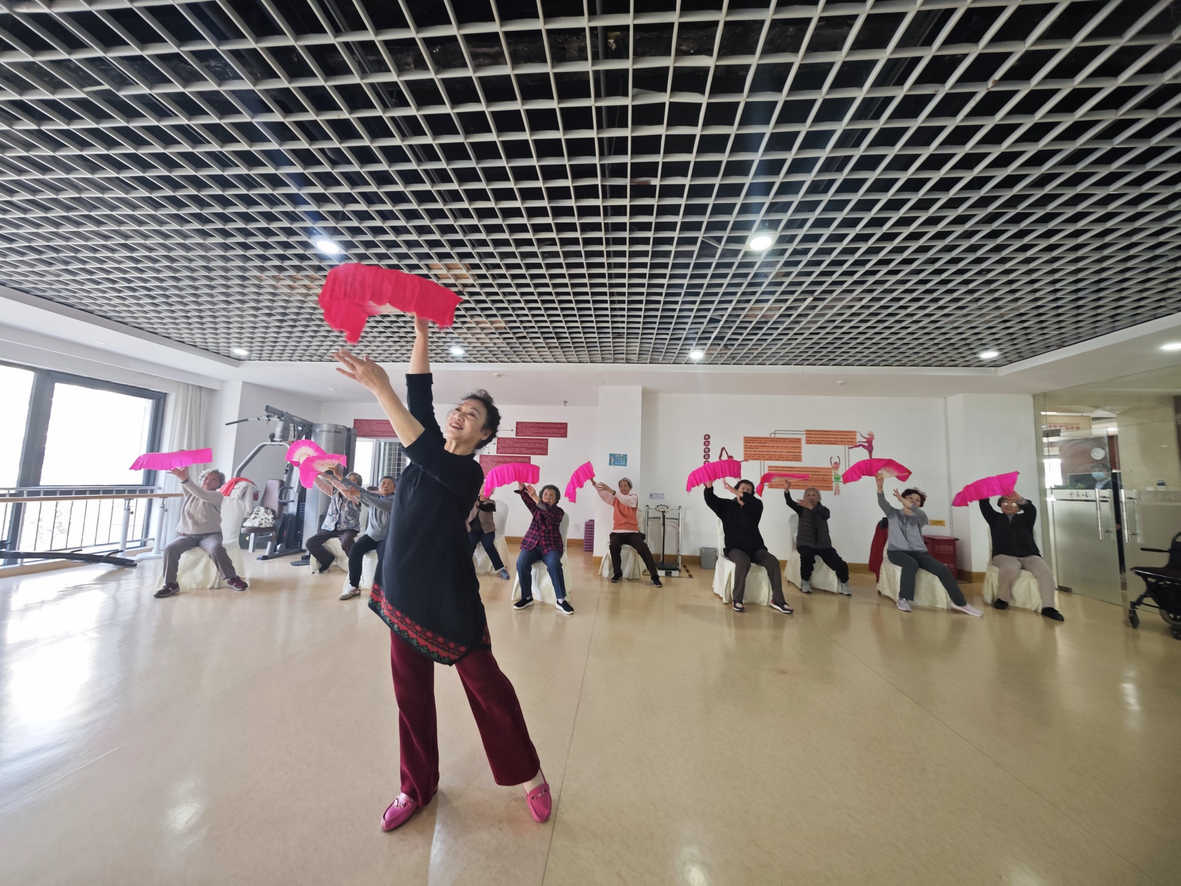 养老机构里的老人正在练习扇子舞。人民网记者 王天乐摄